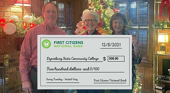 John Tucker (left) and Kerrie Heckethorn (right) present Dr. Karen Bowyer (center) with a check for $500 for raising the largest donation during an hour of giving during the Giving Tuesday 731 fundraising campaign in November.