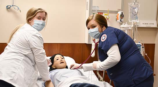 Students in Nursing lab practicing patient care.